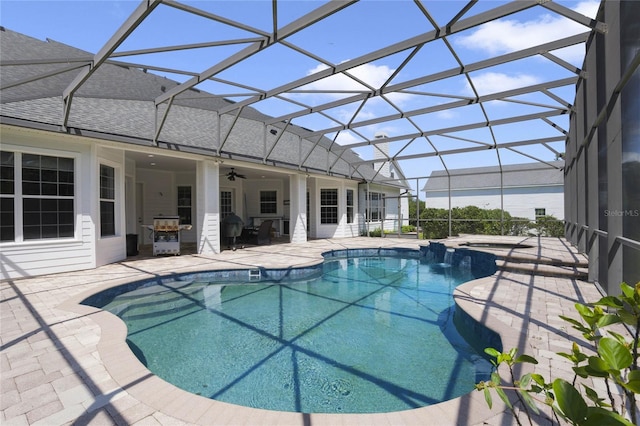 view of pool featuring a patio, a pool with connected hot tub, a lanai, and a ceiling fan