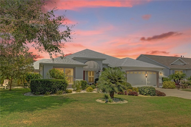 view of front of property featuring a yard and a garage