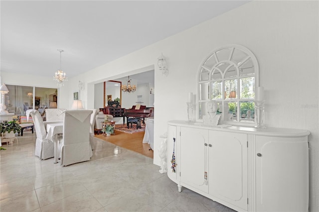 interior space with an inviting chandelier and light hardwood / wood-style flooring