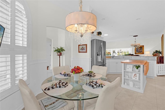 tiled dining room featuring a chandelier