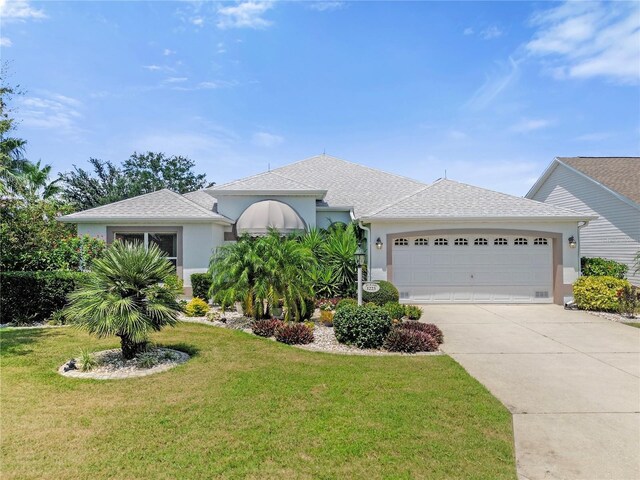 ranch-style house with a garage and a front lawn