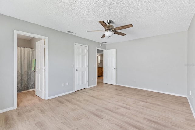 unfurnished bedroom with a textured ceiling, ceiling fan, a closet, and light wood-type flooring