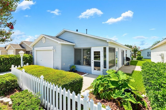 view of front of property featuring a sunroom