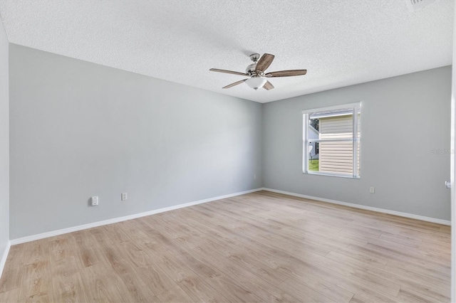 spare room with a textured ceiling, ceiling fan, and light hardwood / wood-style floors