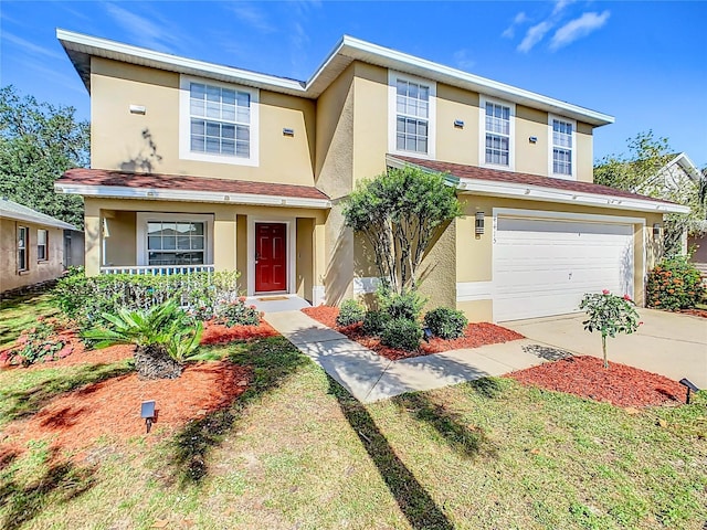 view of front of property featuring a porch, stucco siding, driveway, and an attached garage