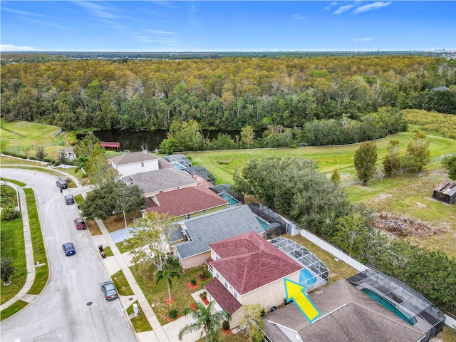 birds eye view of property with a view of trees