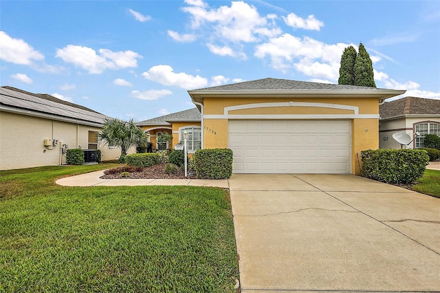 view of front of home featuring a garage, central AC, and a front yard