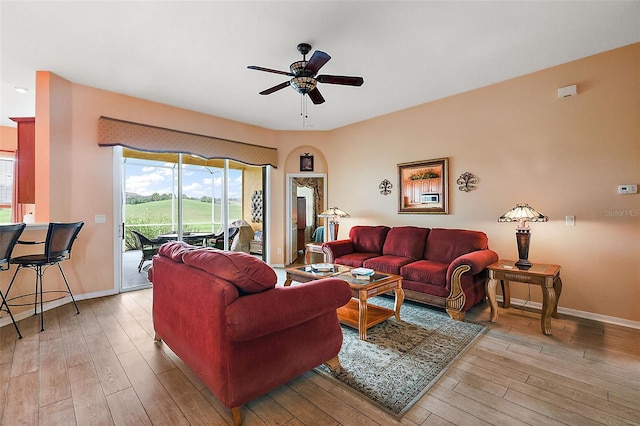 living room featuring ceiling fan and light wood-type flooring