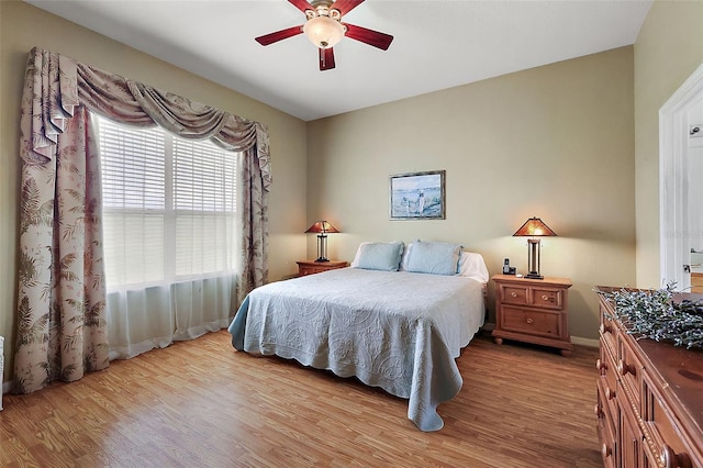 bedroom featuring light wood-type flooring and ceiling fan