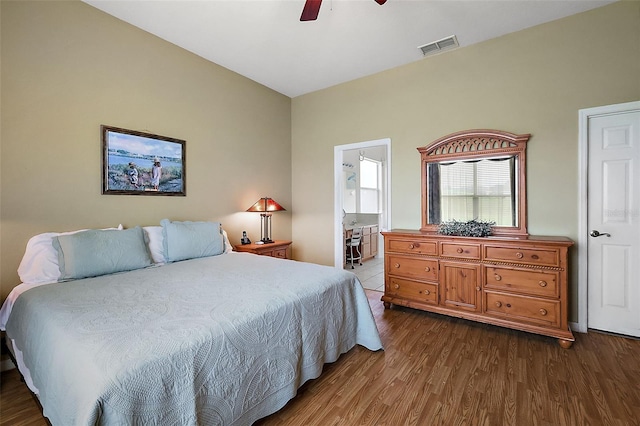 bedroom featuring wood-type flooring, ensuite bath, and ceiling fan