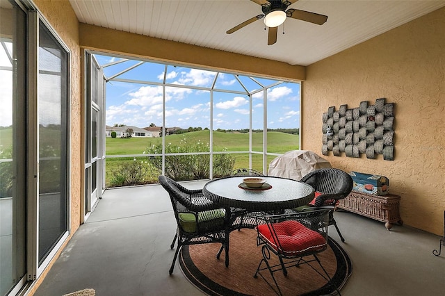 sunroom / solarium featuring ceiling fan and plenty of natural light