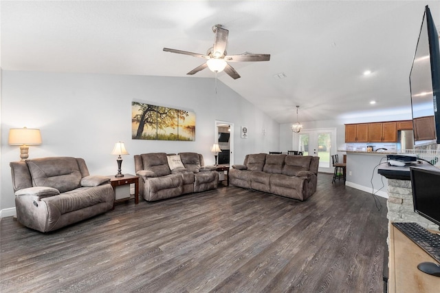 living room featuring ceiling fan with notable chandelier, dark hardwood / wood-style flooring, and lofted ceiling