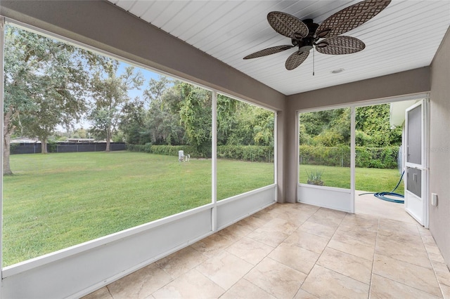 unfurnished sunroom featuring ceiling fan