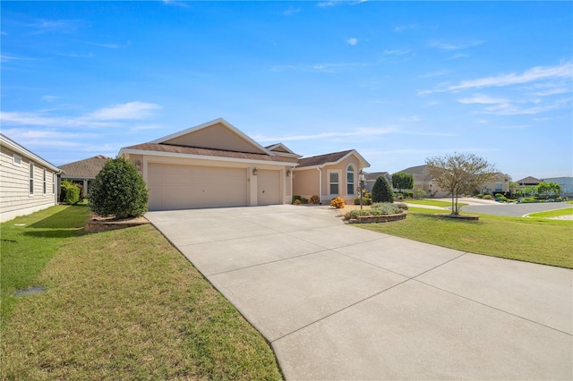 ranch-style house featuring a front yard and a garage