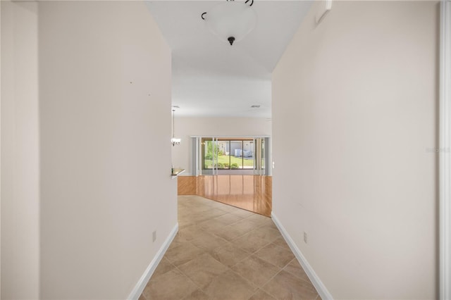 corridor with light tile patterned flooring