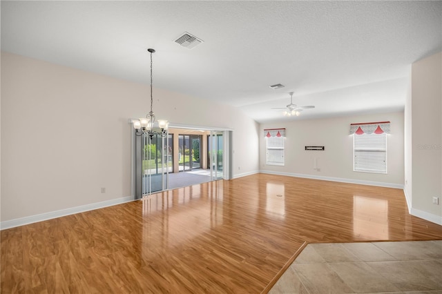 interior space featuring a textured ceiling, light hardwood / wood-style flooring, and ceiling fan with notable chandelier