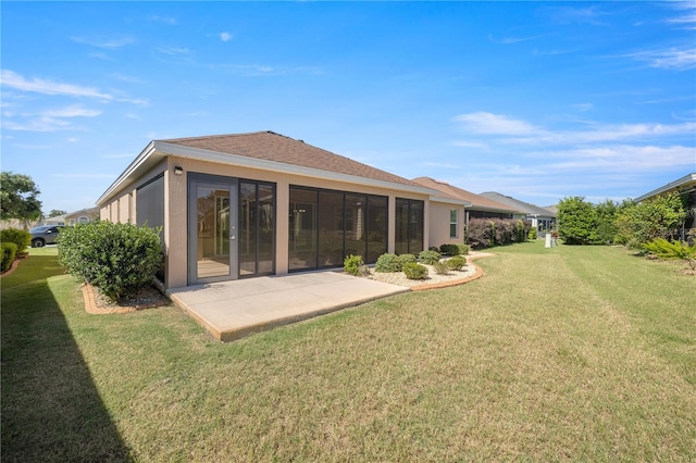 back of property featuring a patio, a sunroom, and a lawn