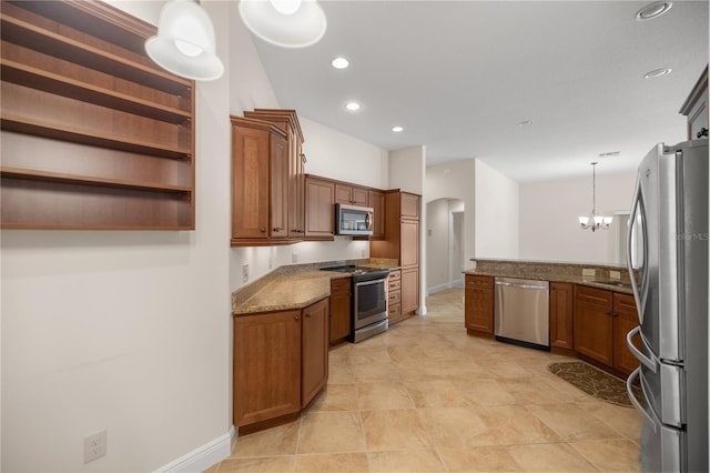 kitchen with stainless steel appliances, sink, light stone countertops, a notable chandelier, and pendant lighting