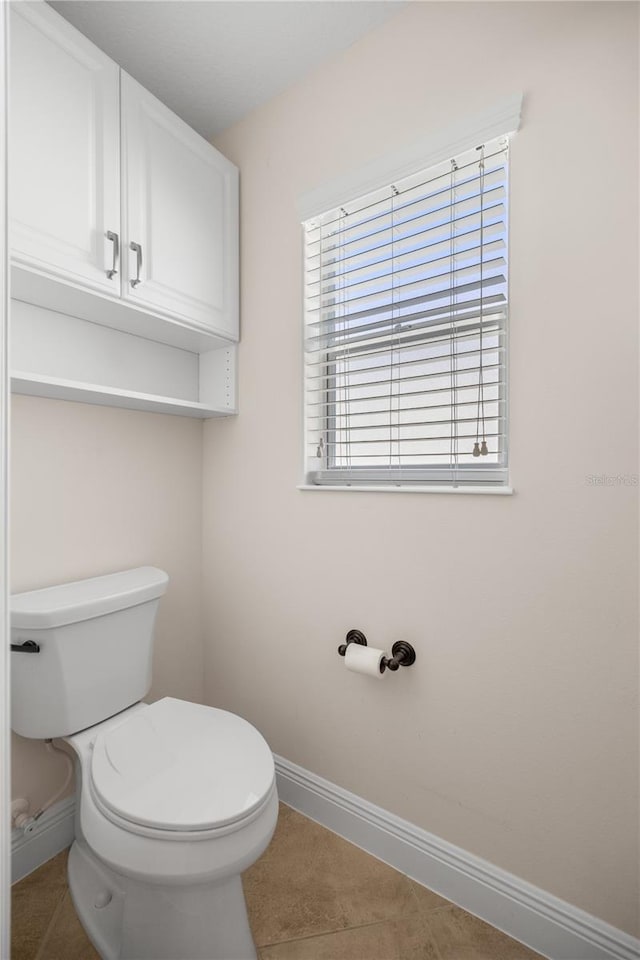 bathroom featuring toilet and tile patterned flooring