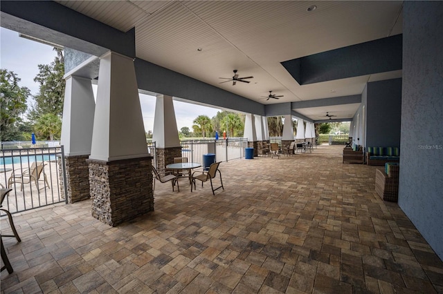 view of patio with a fenced in pool and ceiling fan