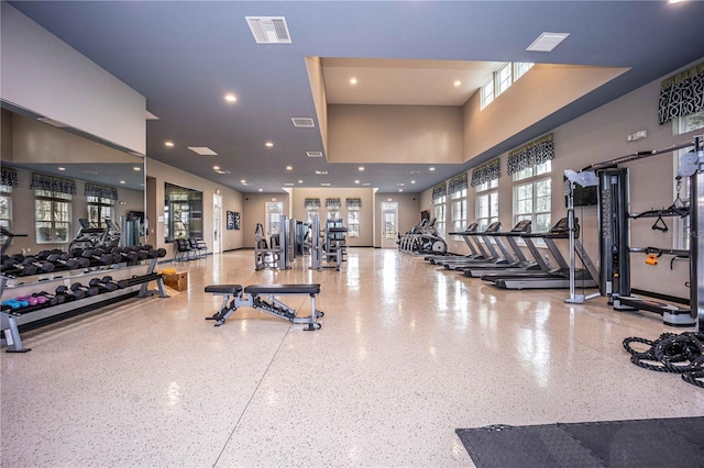 gym with a towering ceiling