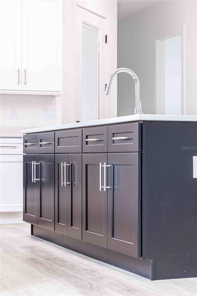 kitchen featuring white cabinetry and light wood-type flooring