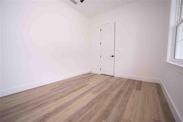 spare room with light hardwood / wood-style flooring