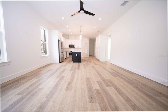 unfurnished living room with light hardwood / wood-style flooring and ceiling fan