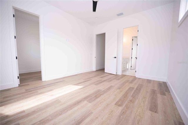 spare room featuring light hardwood / wood-style floors and ceiling fan