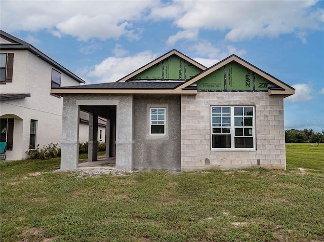 rear view of property with a lawn