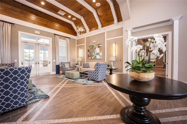 interior space with beamed ceiling, a towering ceiling, wooden ceiling, french doors, and hardwood / wood-style flooring