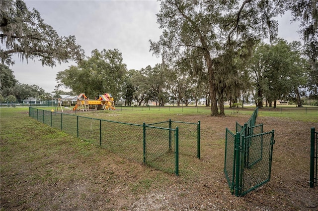 view of home's community featuring a yard and a playground