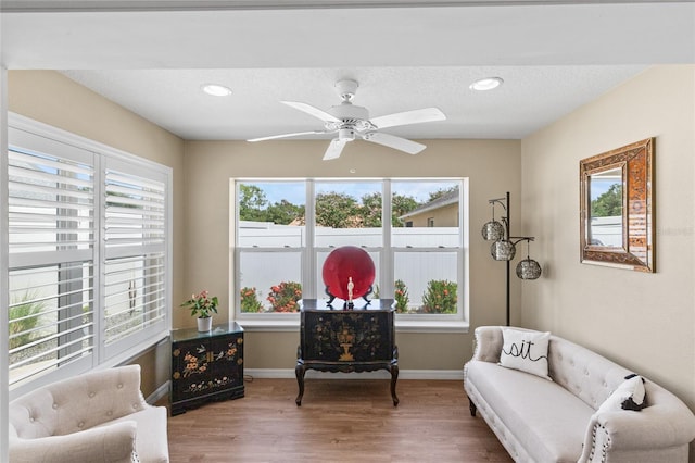 living area featuring recessed lighting, baseboards, a ceiling fan, and wood finished floors