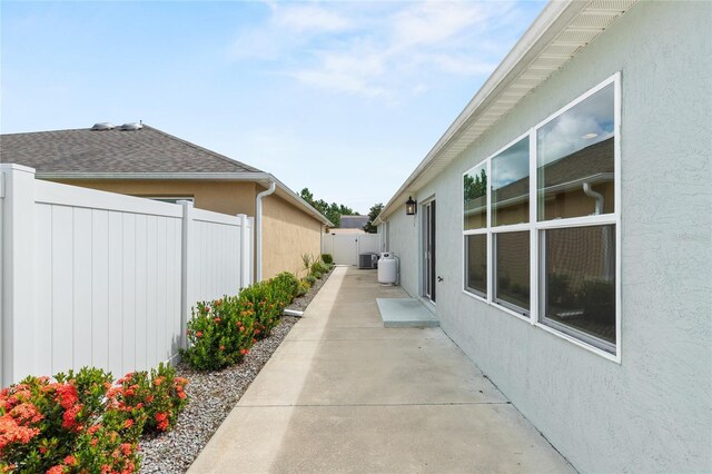 view of property exterior with a patio area and central AC