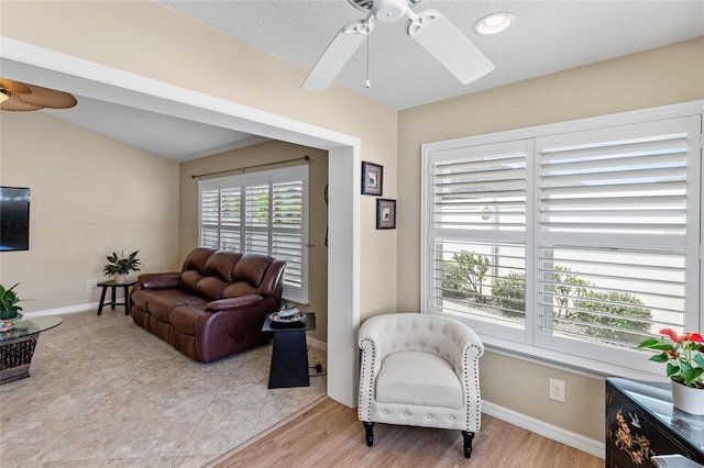 living room with light wood-type flooring and ceiling fan