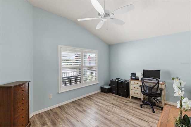 home office with vaulted ceiling, ceiling fan, and light wood-type flooring