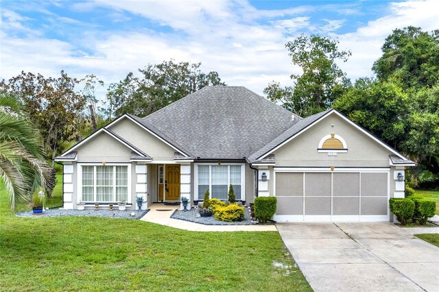 single story home with a garage and a front yard