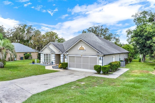 ranch-style home featuring a garage, a front yard, driveway, and stucco siding