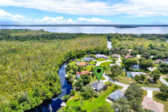 bird's eye view featuring a forest view and a water view