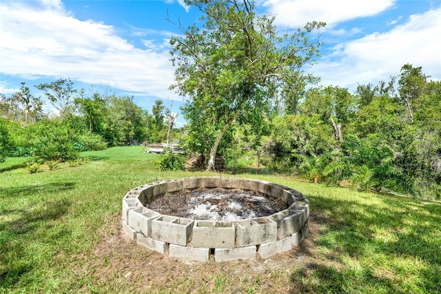 view of yard with a fire pit