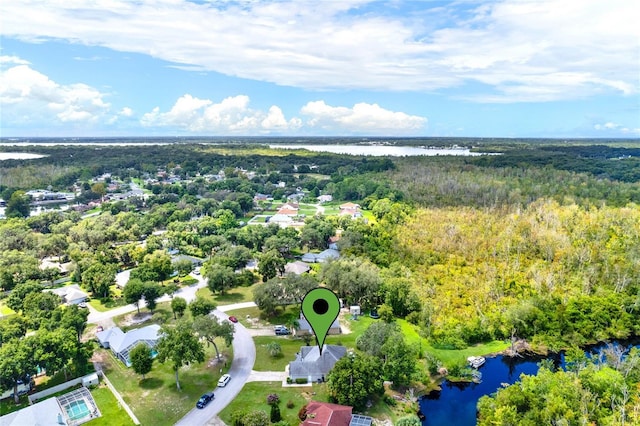 bird's eye view featuring a view of trees and a water view