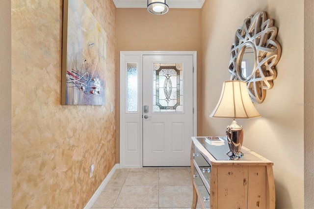 tiled foyer entrance featuring crown molding