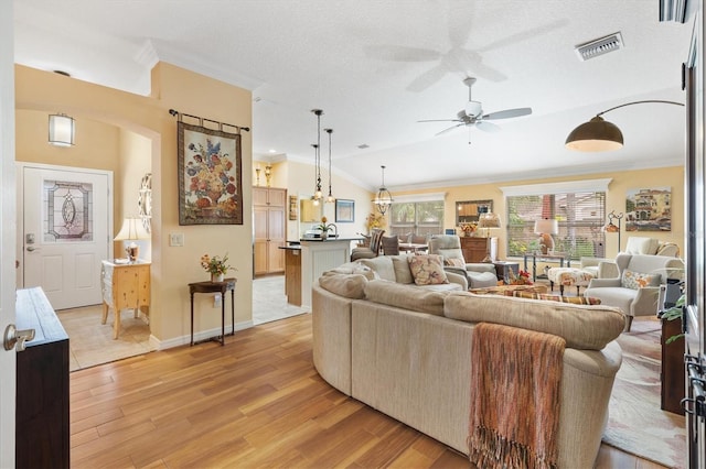 living room featuring a textured ceiling, lofted ceiling, ceiling fan, and light hardwood / wood-style floors