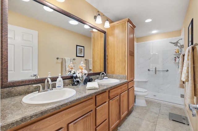 bathroom featuring a shower with door, vanity, toilet, and tile patterned floors