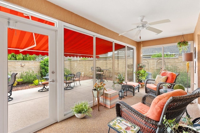 sunroom / solarium featuring ceiling fan