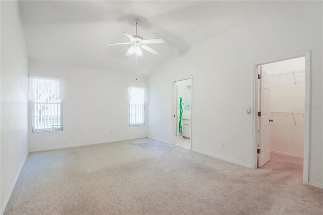 unfurnished room featuring light carpet, lofted ceiling, ceiling fan, and plenty of natural light