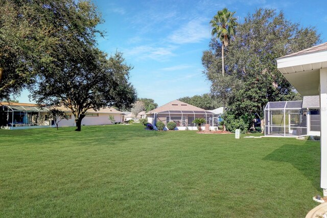 view of yard featuring glass enclosure