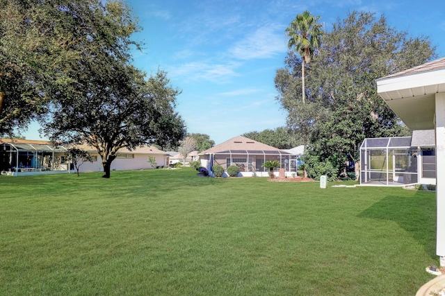 view of yard with glass enclosure