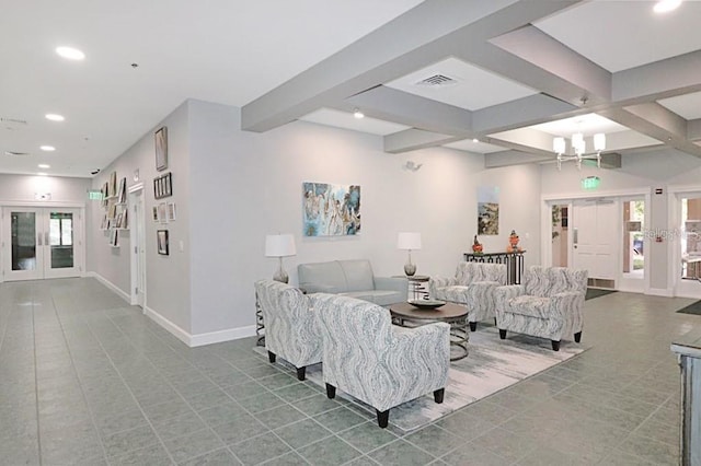 living room featuring a notable chandelier, beam ceiling, and a wealth of natural light