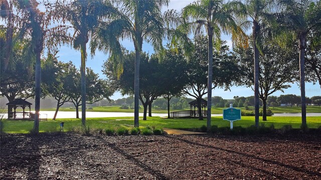 exterior space with a lawn, a water view, and a gazebo